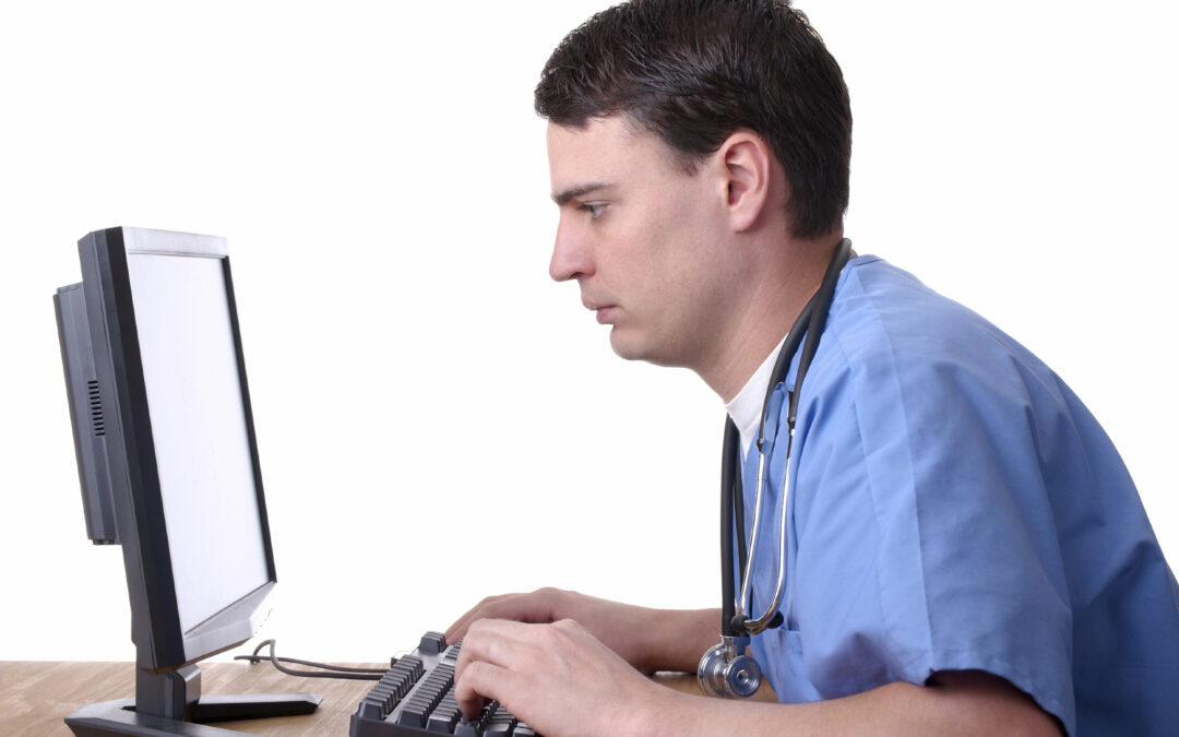 Image of clinician entering data into a computer
