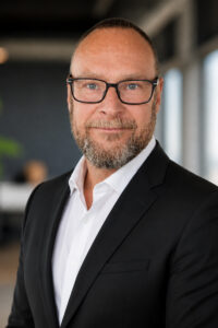 Photograph of John McCann, Vice President of Global Marketing at BridgeHead Software (mid shot)