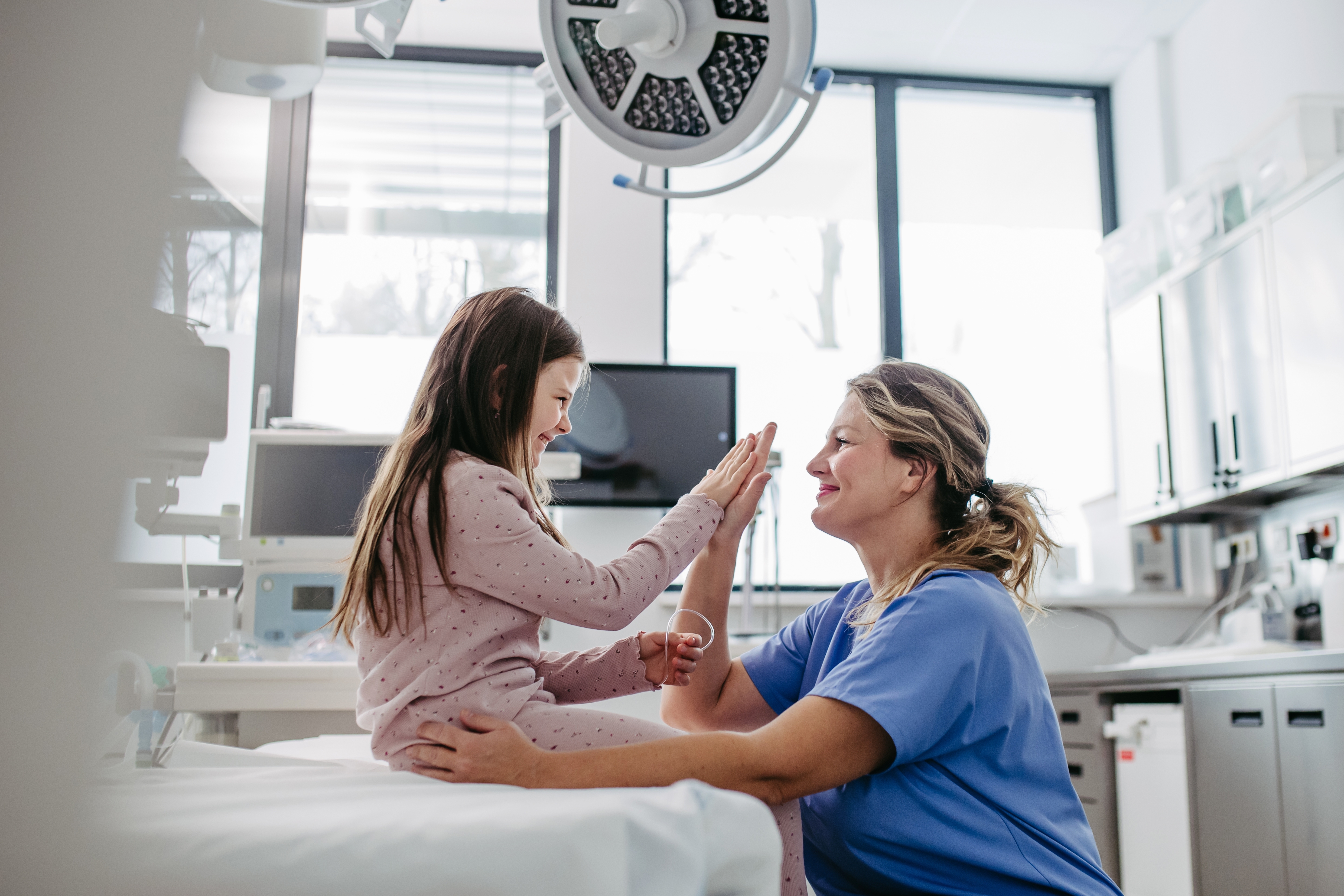 NHS Doctor with child patient in examining room Image of NHS Doctor with child patient in examining room